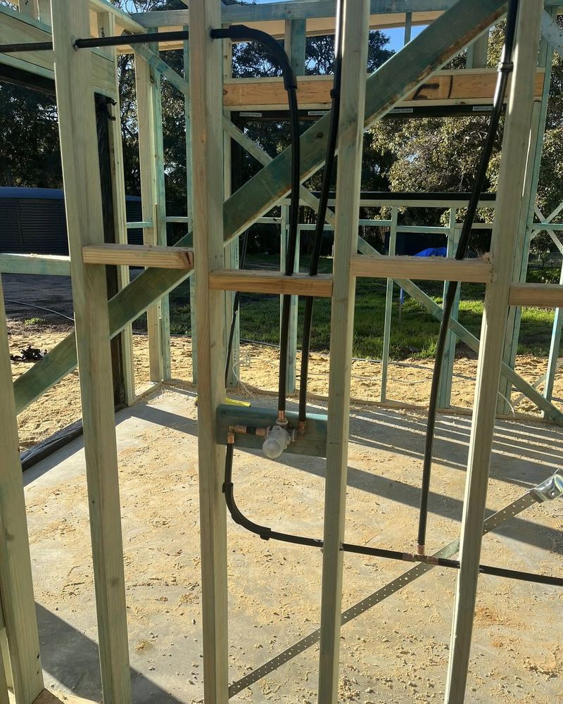 Plumbing rough-in through the timber frame of a new home